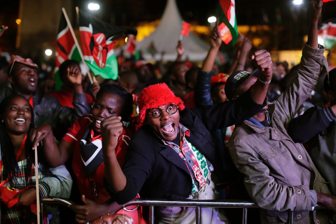 Supporters of Kenya's President Uhuru Kenyatta cheer as they hear the election results, downtown Nairobi, Kenya,  Friday, Aug. 11, 2017.  Opposition candidate Raila Odinga claimed the vote was rigged. 
