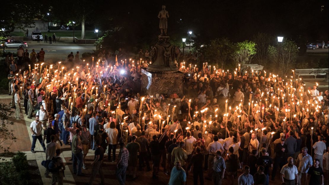 White nationalists carrying torches surround protesters Friday night at the foot of a statue of Thomas Jefferson on the University of Virginia's campus.