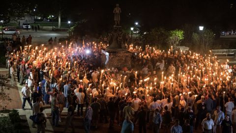 White nationalists carrying torches surround protesters Friday night at the foot of a statue of Thomas Jefferson on the University of Virginia's campus.