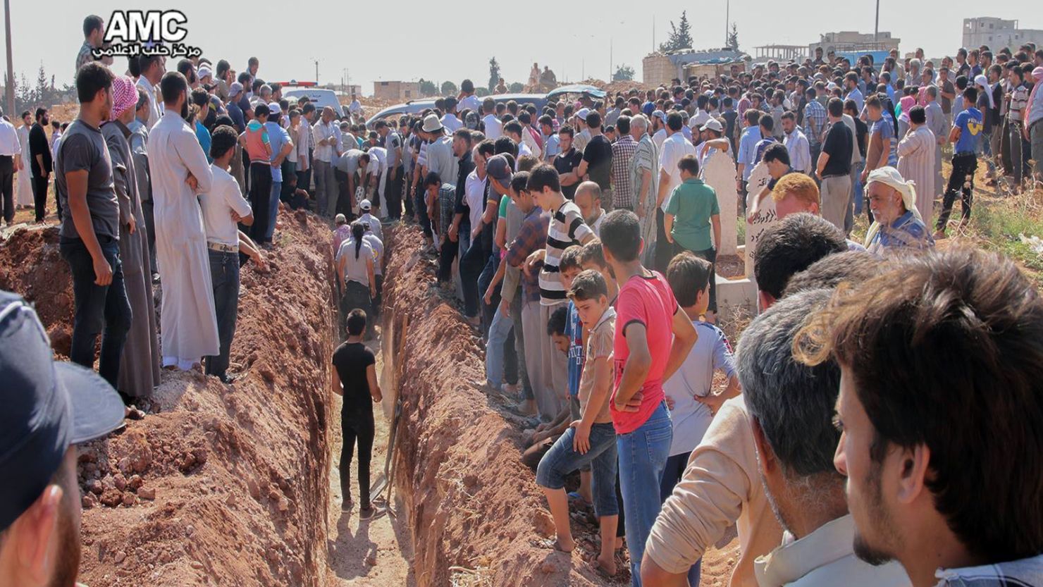 People gather Saturday for the funeral of slain members of the Syrian Civil Defense in Idib province.