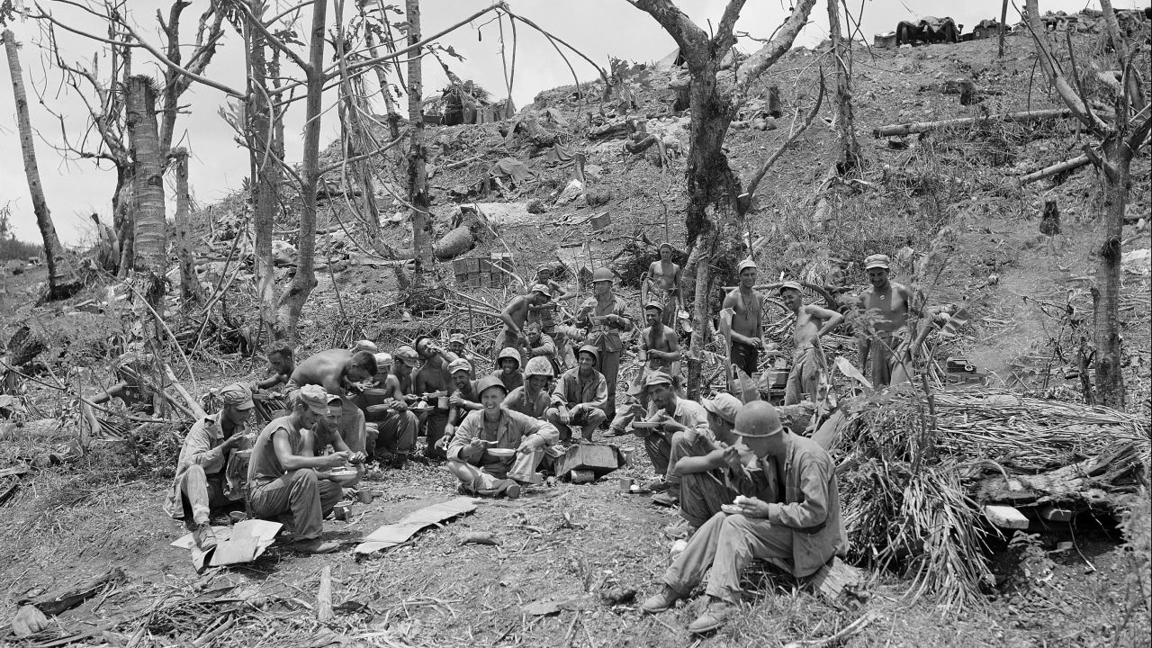 US troops stop to eat on the road to Agana, the capital of Guam, August 10, 1944. The United States took control of Guam after the Second Battle of Guam and turned the island into an important strategic foothold in the Pacific theater. 