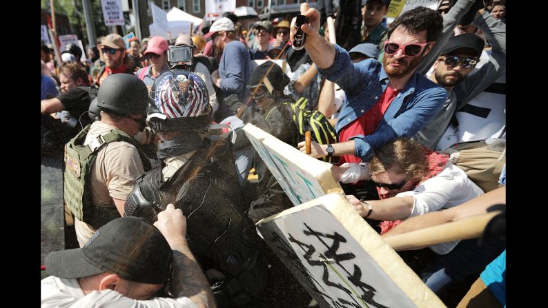 White nationalists, neo-Nazis and members of the alt-right movement exchange volleys of pepper spray with counterprotesters as they enter Emancipation Park.