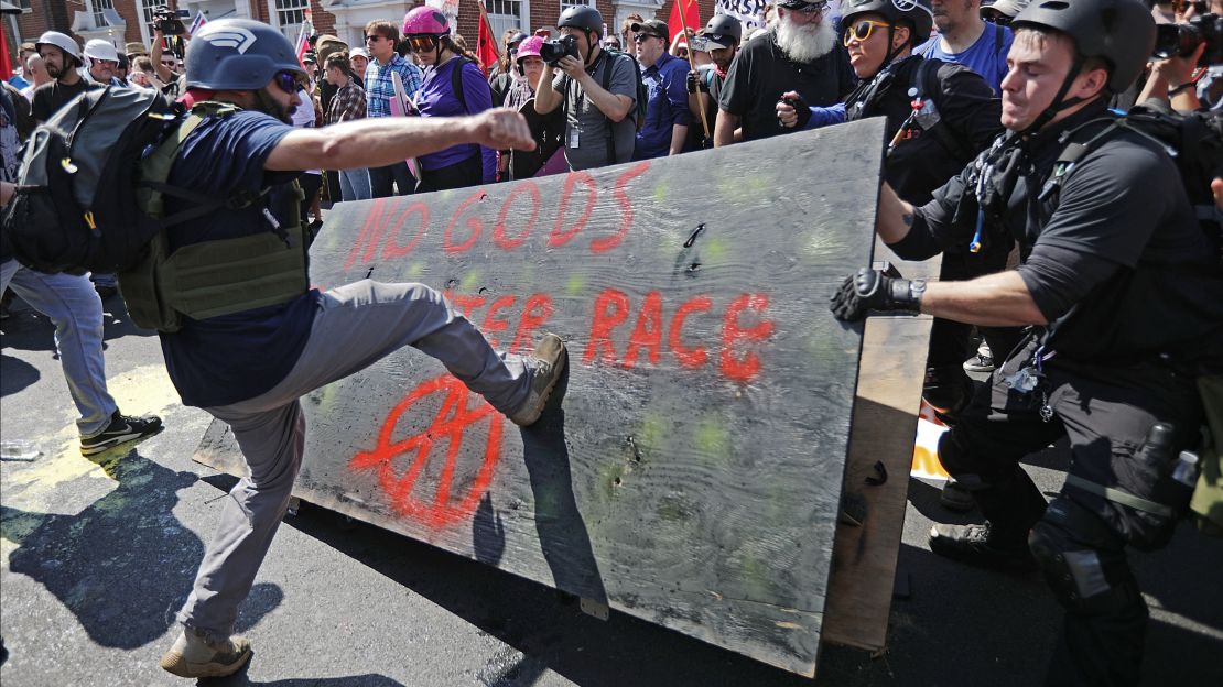 White nationalists, neo-Nazis and members of the "alt-right" clash with counterprotesters as they enter Lee Park during the "Unite the Right" rally August 12, 2017, in Charlottesville.