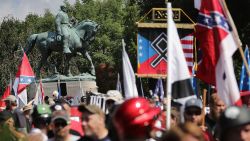 The statue of Confederate General Robert E. Lee stands behind a crowd of hundreds of white nationalists, neo-Nazis and members of the "alt-right" during the "Unite the Right" rally August 12, 2017 in Charlottesville, Virginia. After clashes with anti-fascist protesters and police the rally was declared an unlawful gathering and people were forced out of Lee Park, where a statue of Confederate General Robert E. Lee is slated to be removed. 