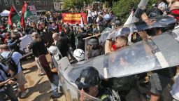 White nationalist demonstrators use shields as they clash with counter demonstrators at the entrance to Lee Park in Charlottesville, Virginia, Saturday, August 12, 2017.   Hundreds of people chanted, threw punches, hurled water bottles and unleashed chemical sprays on each other Saturday after violence erupted at a white nationalist rally in Virginia. At least one person was arrested. 