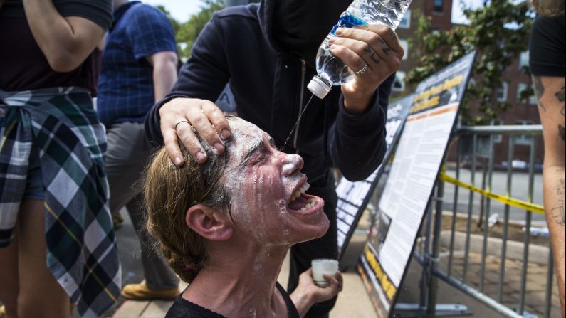 A woman is treated for exposure to pepper spray during clashes between white nationalists and counterprotesters at Emancipation Park.