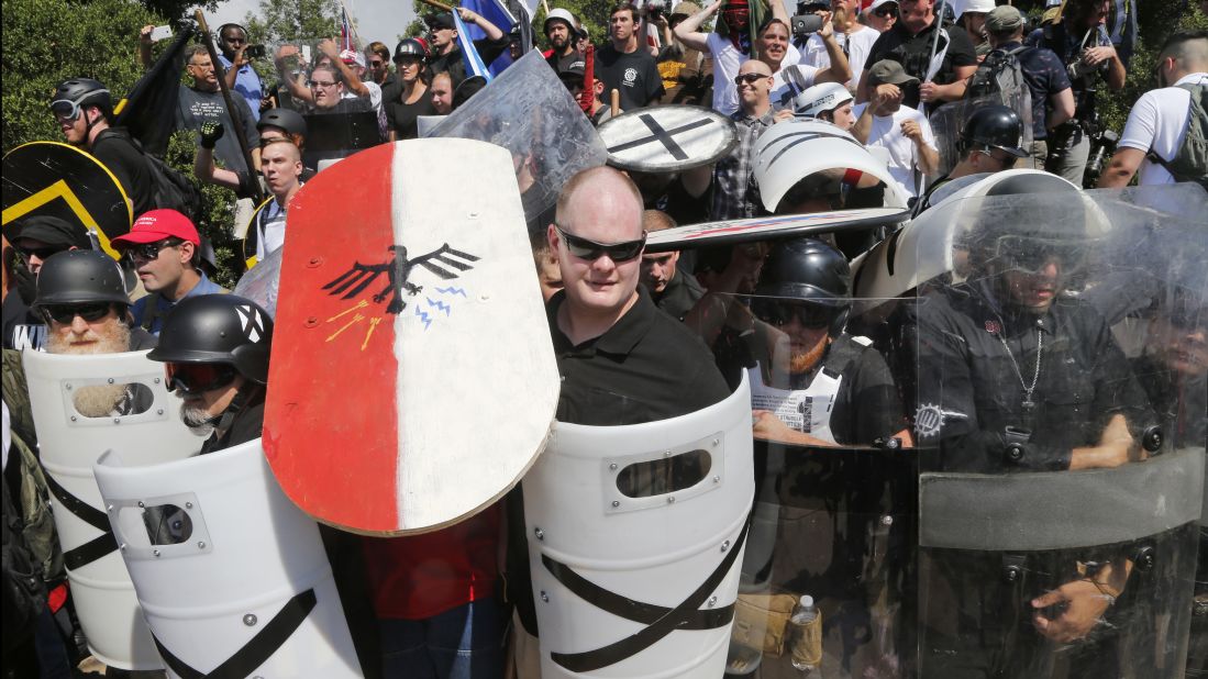 White nationalists use shields as they guard the entrance to Emancipation Park.