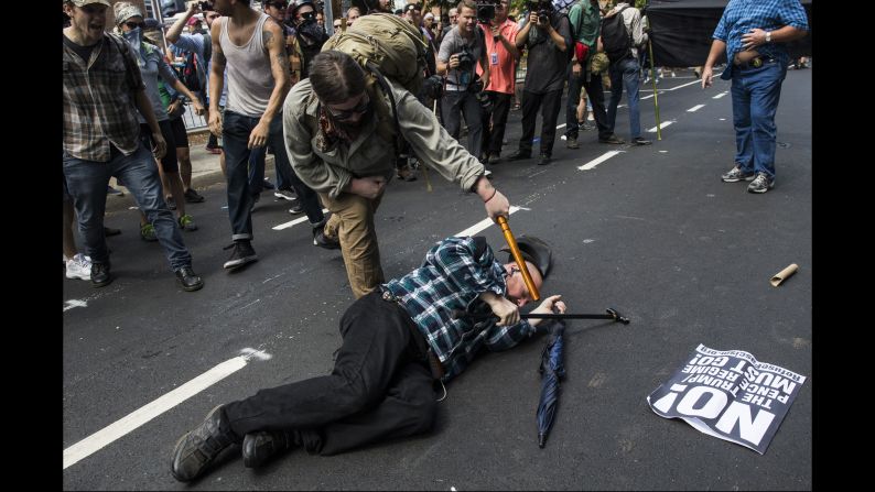 A counterprotester strikes a white nationalist with a baton during clashes at Emancipation Park, where white nationalists are protesting the removal of the Confederate Gen. Robert E. Lee monument. 