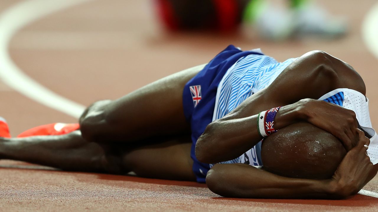 Britain's Mo Farah slumps to the track in disappointment after failing in his bid for gold in the 5,000m at the world athletics championship in London.  