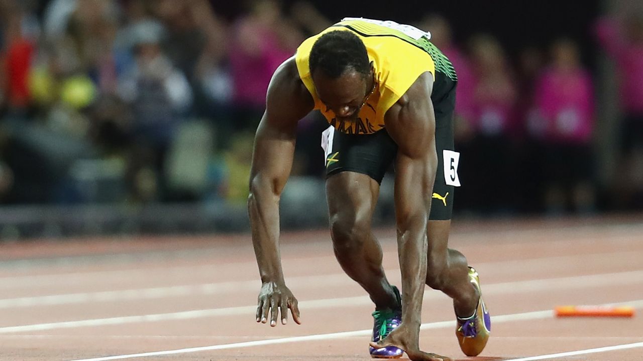 Bolt falls to the track on the final leg of the sprint relay.