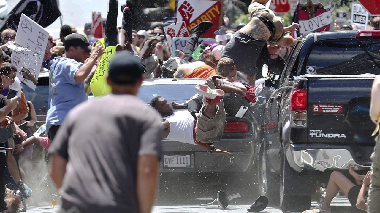 People fly into the air as a vehicle drives into a group of protesters demonstrating against a white nationalist rally in Charlottesville, Virginiaon Saturday, August 12, 2017. The nationalists were holding the rally to protest plans by the city of Charlottesville to remove a statue of Confederate Gen. Robert E. Lee. There were several hundred protesters marching in a long line when the car drove into a group of them.