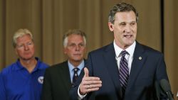 Charlottesville Mayor Mike Signer, right, gestures during a news conference concerning the white nationalist rally and violence as Virginia Gov. Terry McAuliffe, center, and Virginia Secretary of Public safety Brian Moran, left, listen in Charlottesville, Virginia, Saturday, August 12, 2017.