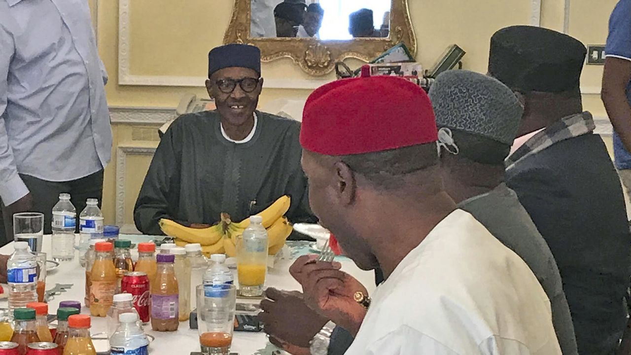 A photo released by the Nigeria State House on July 23 shows President Muhammadu Buhari, back center, during a meeting with Nigeria ruling party's governors in London.