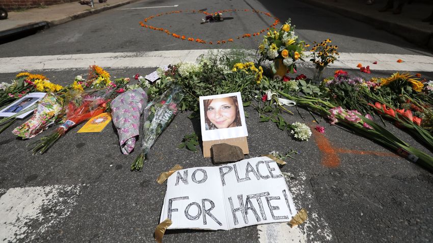 CHARLOTTESVILLE, VA - AUGUST 13:  Flowers surround a photo of 32-year-old Heather Heyer, who was killed when a car plowed into a crowd of people protesting against the white supremacist Unite the Right rally, August 13, 2017 in Charlottesville, Virginia. Charlottesville is calm the day after violence errupted around the Unite the Right rally, a gathering of white nationalists, neo-Nazis, the Ku Klux Klan and members of the 'alt-right,' that left Heyer dead and injured 19 others.  (Photo by Chip Somodevilla/Getty Images)