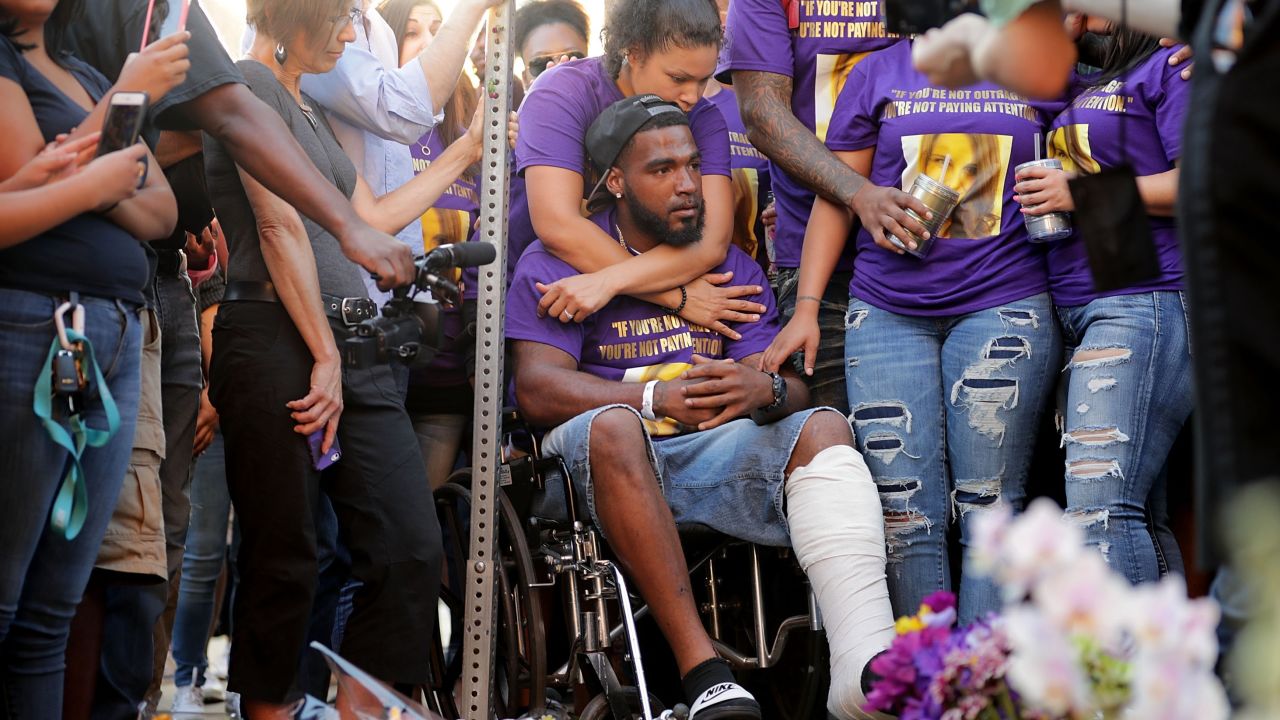 CHARLOTTESVILLE, VA - AUGUST 13:  Marcus Martin (C), who was injured when a car plowed into a crowd of people protesting against the white supremacist Unite the Right rally, his wife Marissa Blair and friends visit the memorial built at the place where he was injured and where where 32-year-old Heather Heyer was killed in the same attack August 13, 2017 in Charlottesville, Virginia. Charlottesville is calm the day after violence errupted around the Unite the Right rally, a gathering of white nationalists, neo-Nazis, the Ku Klux Klan and members of the 'alt-right,' that left Heyer dead and injured 19 others.  (Photo by Chip Somodevilla/Getty Images)