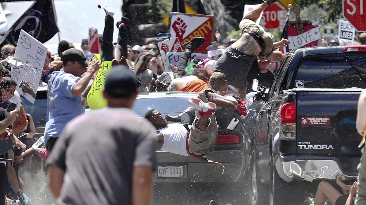 A driver plows into protesters denouncing white supremacists, killing one person and wounding 19. 