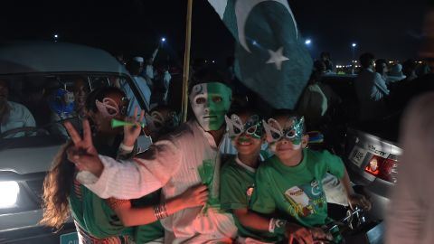 Youths wear masks as they march on a street in Islamabad on the night of August 13, 2017, to mark the country's Independence Day.