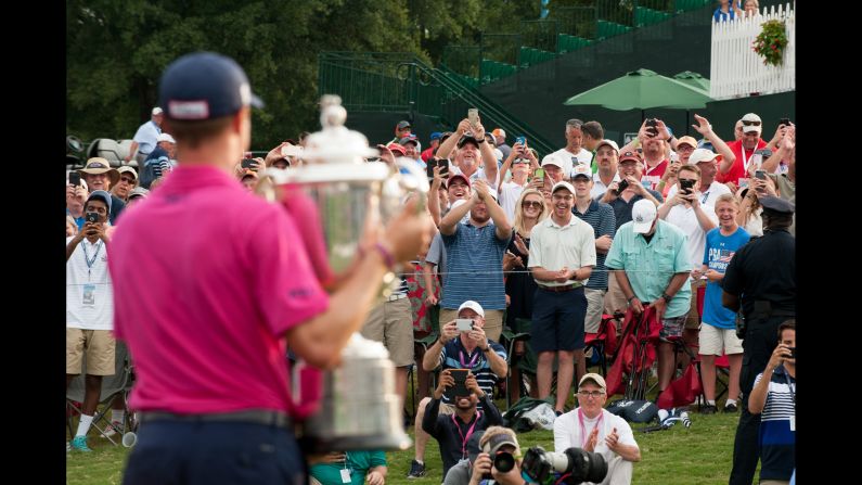 Golf fans cheer Justin Thomas after <a href="index.php?page=&url=http%3A%2F%2Fwwww.cnn.com%2F2017%2F08%2F13%2Fgolf%2Fpga-championship-thomas-matsuyama-spieth%2Findex.html" target="_blank">he won the PGA Championship</a> in Charlotte, North Carolina, on Sunday, August 13. It was the first major title for Thomas, a 24-year-old American.