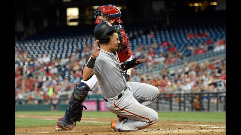 San Francisco's Joe Panik collides with Washington catcher Matt Wieters during a play at the plate on Sunday, August 13.