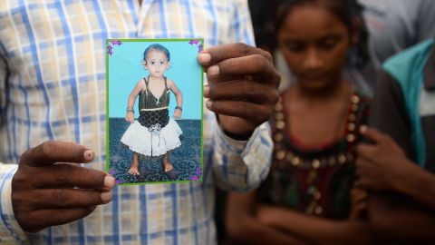 Mohammad Zahid, who lost his five-and-a-half year old daughter Khushi, holds his daughter's photograph in Gorakhpur in the Indian state of Uttar Pradesh, on August 14.