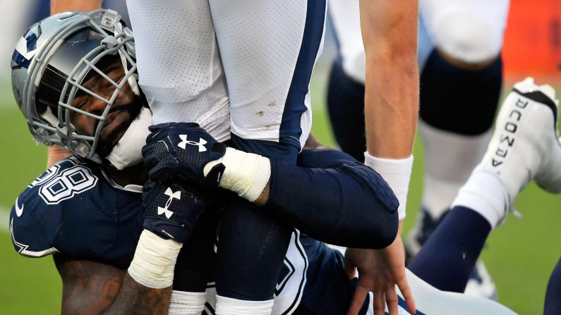 Dallas defensive end Damontre Moore wraps up Los Angeles Rams quarterback Sean Mannion during an NFL preseason game on Saturday, August 12.