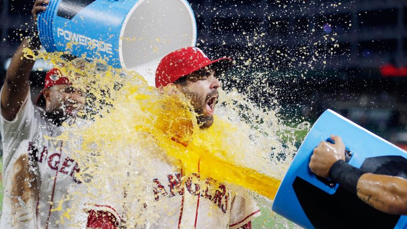 Texas catcher Brett Nicholas is doused by teammates after their win over Houston on Saturday, August 12. Nicholas had a three-run homer in the 8-3 victory.  