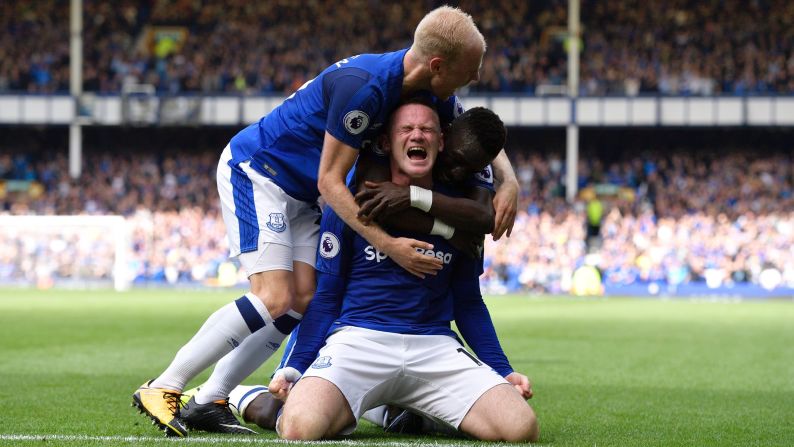 Wayne Rooney is hugged by Everton teammates Davy Klaassen, left, and Idrissa Gueye after scoring a goal against Stoke City on Saturday, August 12. It was Rooney's first Premier League goal since returning to his boyhood club this summer, and Everton held on to win 1-0.