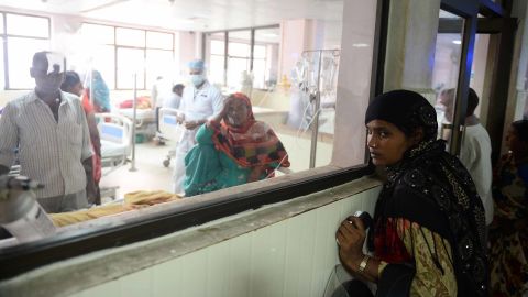 Indian relatives of patients wait outside the encephalitis ward at the Baba Raghav Das Hospital in Gorakhpur on August 14.