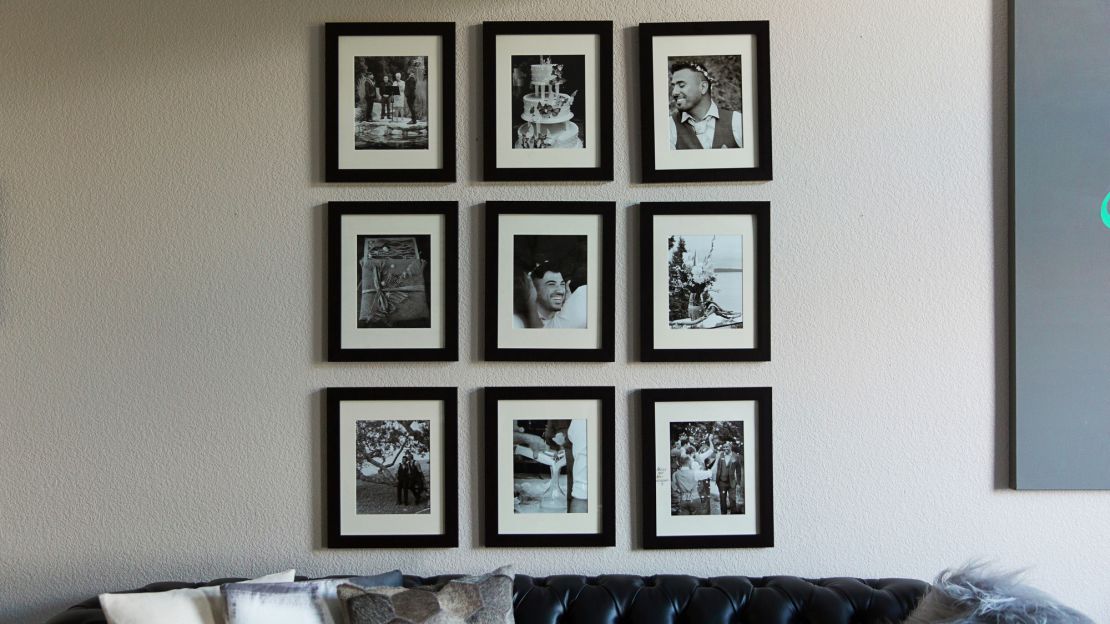 Wedding photos decorate a wall in their living room in Seattle.
