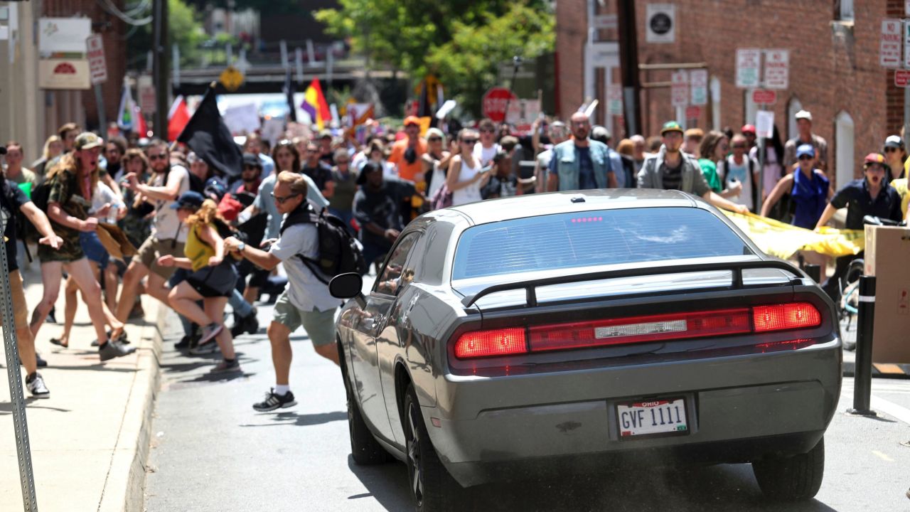 Demonstrators bolted out of the way of a car just before it struck the group of counterprotesters. 