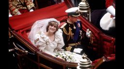 The Prince and Princess of Wales return to Buckingham Palace by carriage after their wedding, July 29, 1981. She wears a wedding dress by David and Elizabeth Emmanuel and the Spencer family tiara. 