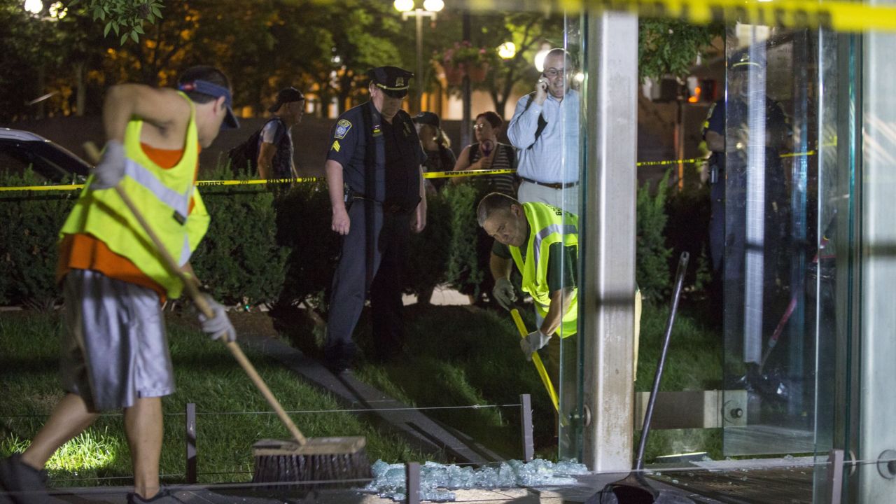 Workers clean up broken glass at the New England Holocaust Memorial.
