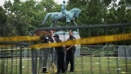 Police stand watch near the statue of Confederate Gen. Robert E. Lee in the center of Emancipation Park in Charlottesville
