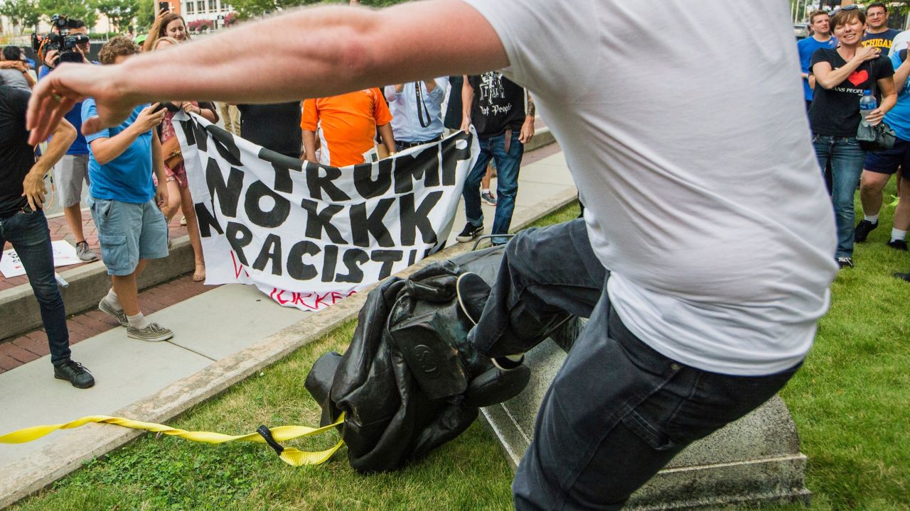 Protesters kick the fallen statue of a Confederate soldier in Durham, North Carolina.