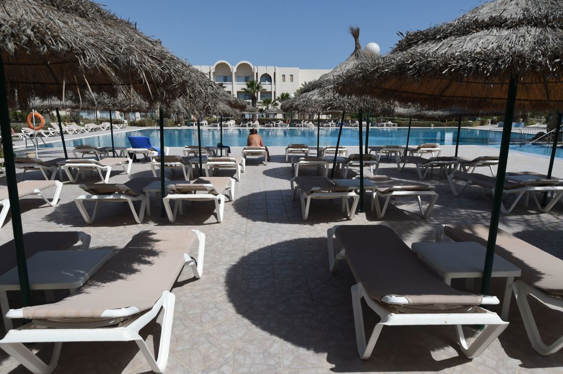 A tourist on a sunbed on the Tunisian resort island of Djerba. Visitor numbers fell by 25% in 2015 after ISIS attacks on tourist sites. 