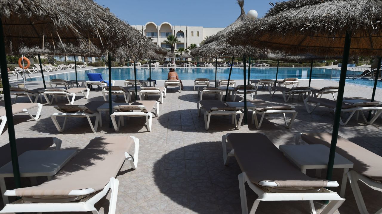 A tourist on a sunbed on the Tunisian resort island of Djerba. Visitor numbers fell by 25% in 2015 after ISIS attacks on tourist sites. 