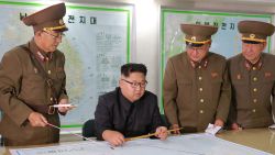 TOPSHOT - This picture taken on August 14, 2017 and released from North Korea's official Korean Central News Agency (KCNA) on August 15, 2017 shows North Korean leader Kim Jong-Un (C) inspecting the Command of the Strategic Force of the Korean People's Army (KPA) at an undisclosed location.
North Korean leader Kim Jong-Un said on August 15 he would hold off on a planned missile strike near Guam, but warned the highly provocative move would go ahead in the event of further "reckless actions" by Washington. / AFP PHOTO / KCNA VIA KNS / STR / South Korea OUT / REPUBLIC OF KOREA OUT   ---EDITORS NOTE--- RESTRICTED TO EDITORIAL USE - MANDATORY CREDIT "AFP PHOTO/KCNA VIA KNS" - NO MARKETING NO ADVERTISING CAMPAIGNS - DISTRIBUTED AS A SERVICE TO CLIENTS
THIS PICTURE WAS MADE AVAILABLE BY A THIRD PARTY. AFP CAN NOT INDEPENDENTLY VERIFY THE AUTHENTICITY, LOCATION, DATE AND CONTENT OF THIS IMAGE. THIS PHOTO IS DISTRIBUTED EXACTLY AS RECEIVED BY AFP.  /         (Photo credit should read STR/AFP/Getty Images)
