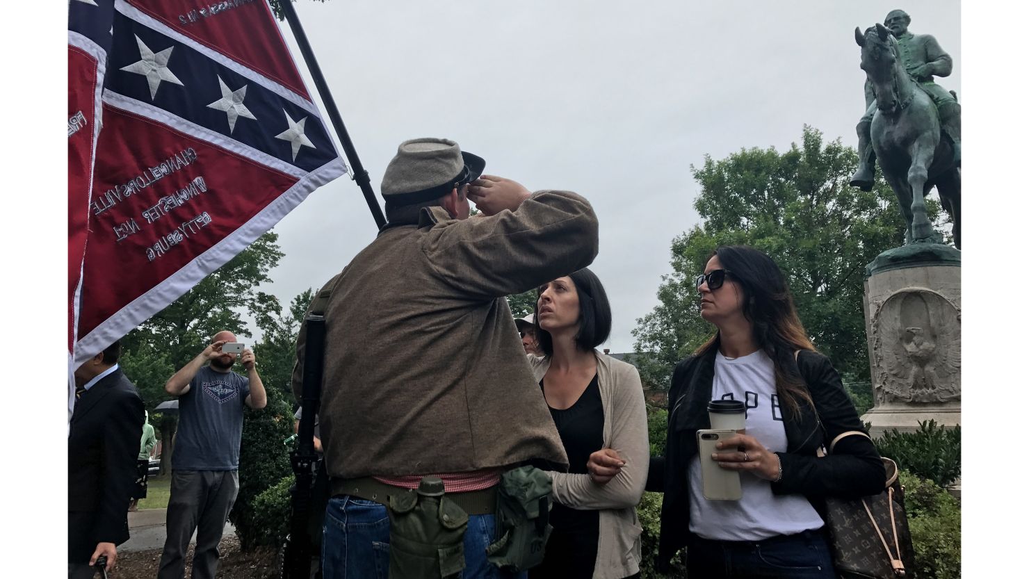 Allen Armentrout salutes a statue of Confederate Gen. Robert E. Lee in Charlottesville, Virginia, on Tuesday. Armentrout was confronted by residents.