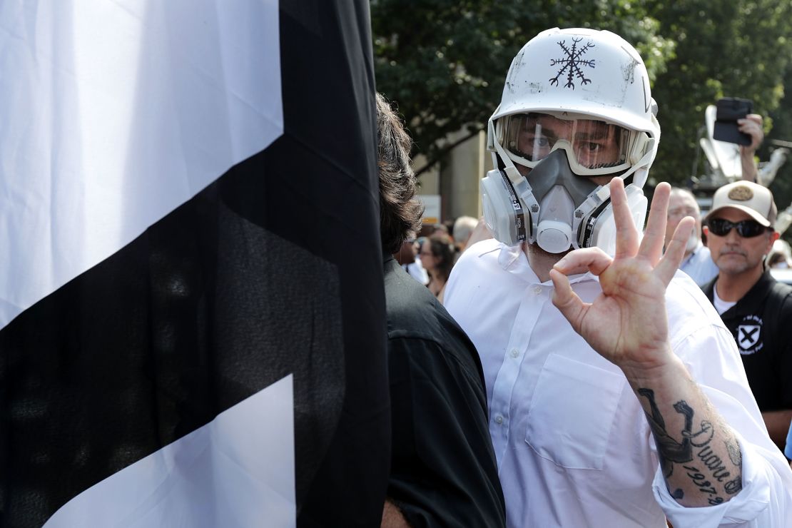 A member of the alt-right displays an 'OK' sign at Charlottesville - one of the seemingly innocuous gestures co-opted by the white power movement.