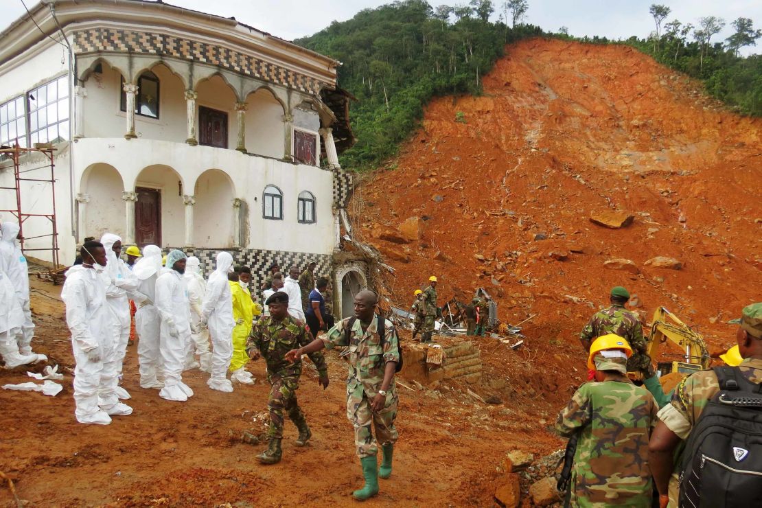 A search-and-rescue team and soldiers operate at the disaster site this week in Freetown.
