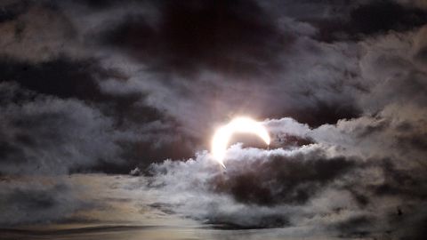 A solar eclipse is partially obscured by clouds December 14,  2001 in Puntarenas, Costa Rica. 