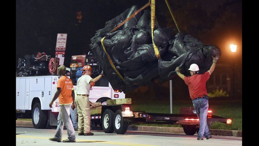 Workers remove a monument dedicated to the Confederate Women of Maryland early Wednesday, Aug. 16, 2017, after it was taken down in Baltimore. Local news outlets reported that workers hauled several monuments away, days after a white nationalist rally in Virginia turned deadly.