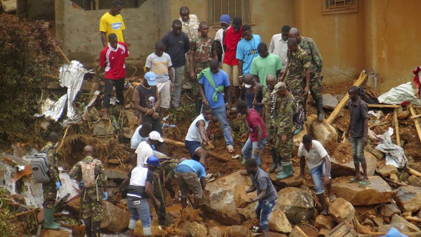 Volunteers search for bodies from the scene of heavy flooding and mudslides in Regent, just outside of Sierra Leone's capital Freetown.
