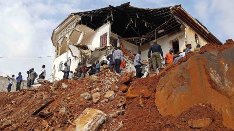People inspect the damage at the mudslide site on Tuesday afternoon. Sierra Leone's President Ernest Bai Koroma has declared seven days of mourning across the country, with immediate effect.