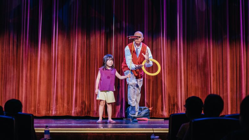 A silent comedian invites a child onto stage at the Fiesta Resort.