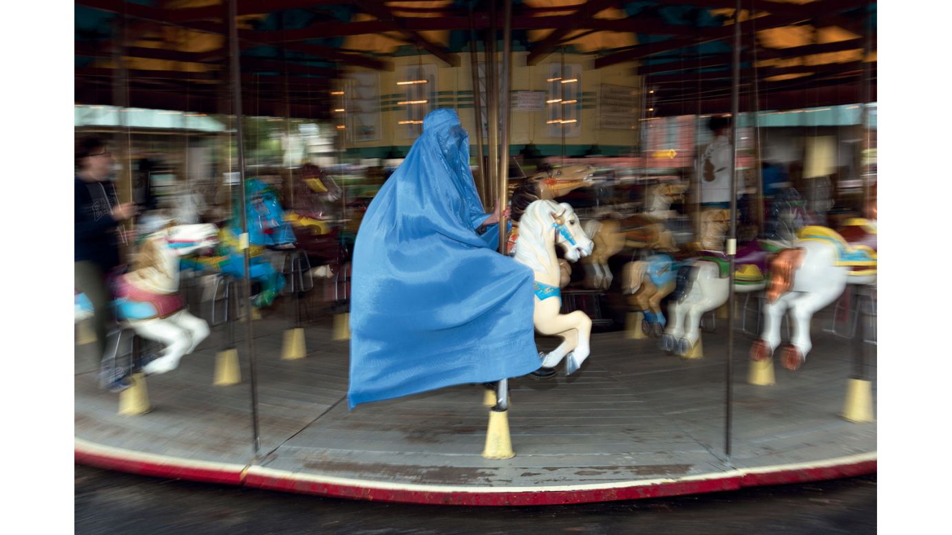 The series depicts her in a traditional blue burqa in everyday American settings.