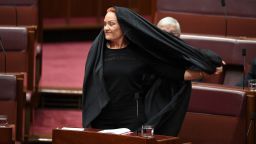 epaselect epa06147929 One Nation Leader Senator Pauline Hanson takes off a full Islamic burqa veil during Senate Question Time at Parliament House in Canberra, Australian Capital Territory, Australia, 17 August 2017. Hanson attended Senate Question Time wearing a full burqa and she is expected to deliver later in the day a speech calling for the banning on full face coverings in public, media reported. Her identity was checked before entering the red chamber, media added.  EPA/LUKAS COCH  AUSTRALIA AND NEW ZEALAND OUT