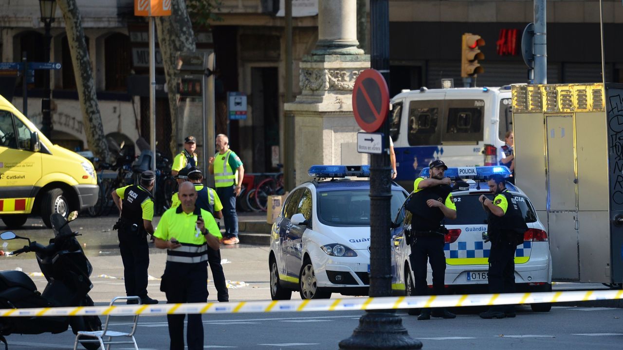 Medical staff members and policemen stand in a cordoned off area after a van ploughed into the crowd, injuring several persons on the Rambla in Barcelona on August 17, 2017.
Police in Barcelona said they were dealing with a "terrorist attack" after a vehicle ploughed into a crowd of pedestrians on the city's famous Las Ramblas boulevard on August 17, 2017. Police were clearing the area after the incident, which has left a number of people injured. / AFP PHOTO / Josep LAGO        (Photo credit should read JOSEP LAGO/AFP/Getty Images)