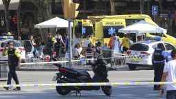 Injured people are treated in Barcelona, Spain, Thursday, Aug. 17, 2017 after a white van jumped the sidewalk in the historic Las Ramblas district, crashing into a summer crowd of residents and tourists and injuring several people, police said. (AP Photo/Oriol Duran)