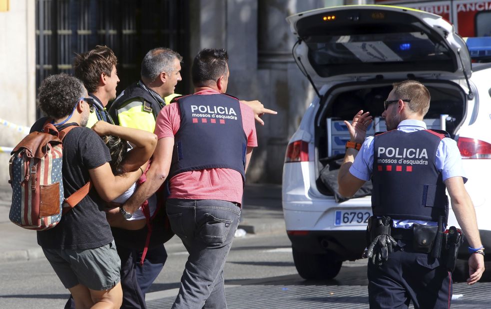 An injured person is carried by police in Barcelona.